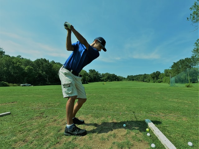 Male golfer with bowed lead wrist in downswing