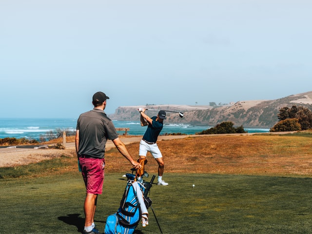 Golfers teeing off on a hole Golfers teeing off on a hole