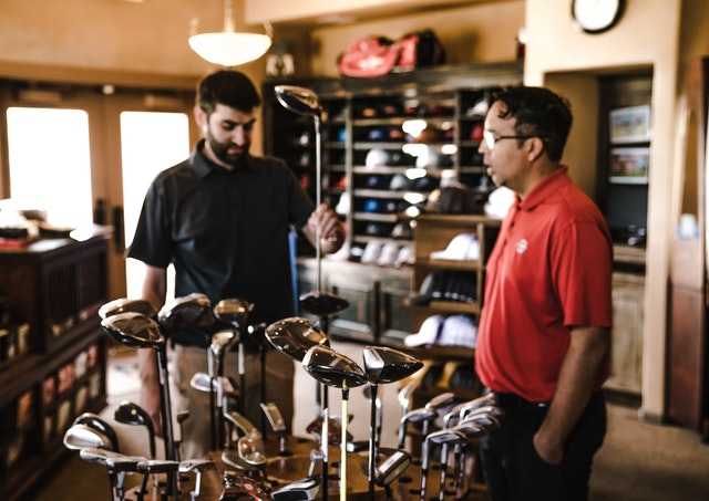 Man buying new golf club